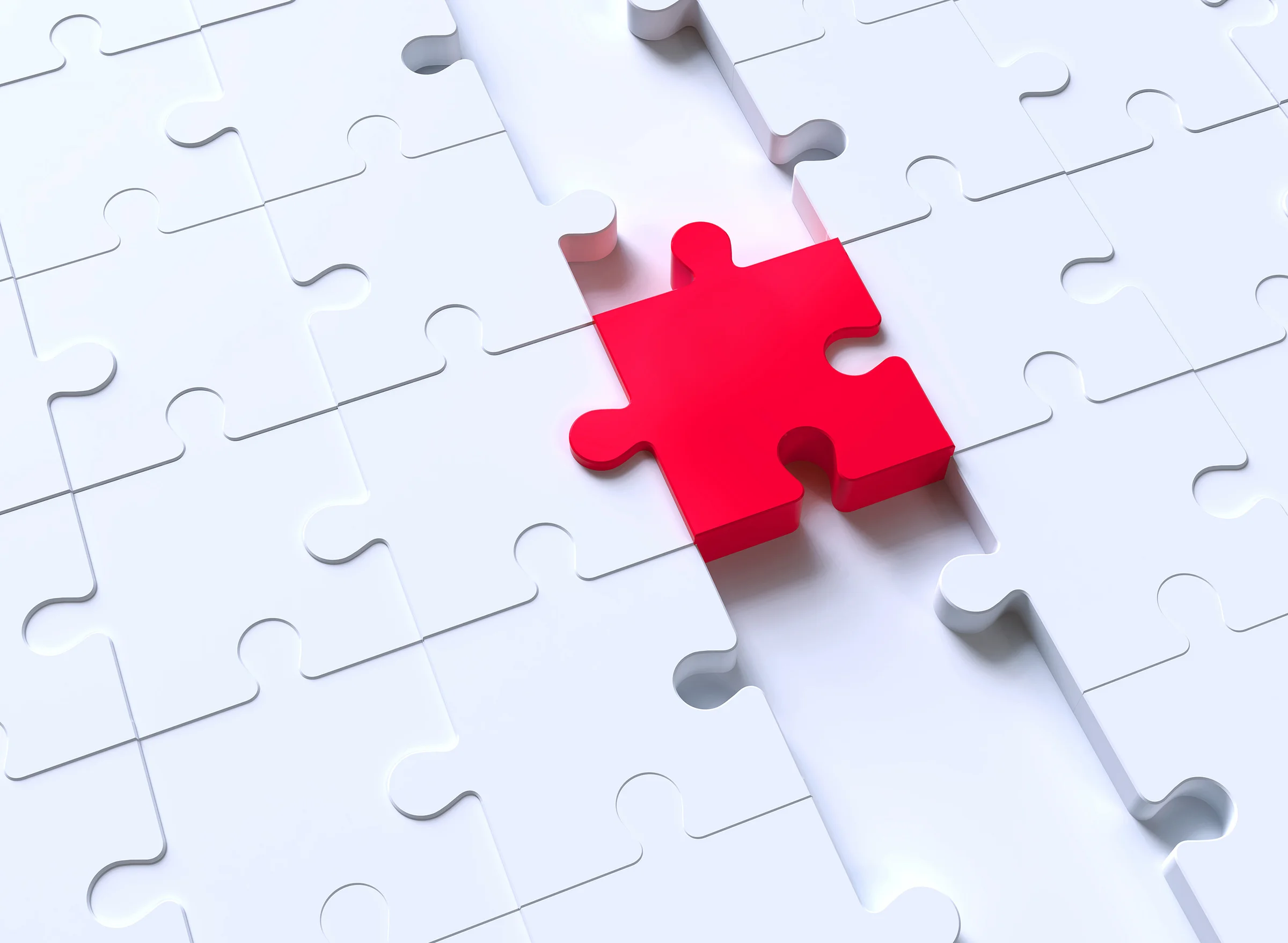 Red puzzle piece completing the gap in an otherwise white puzzle