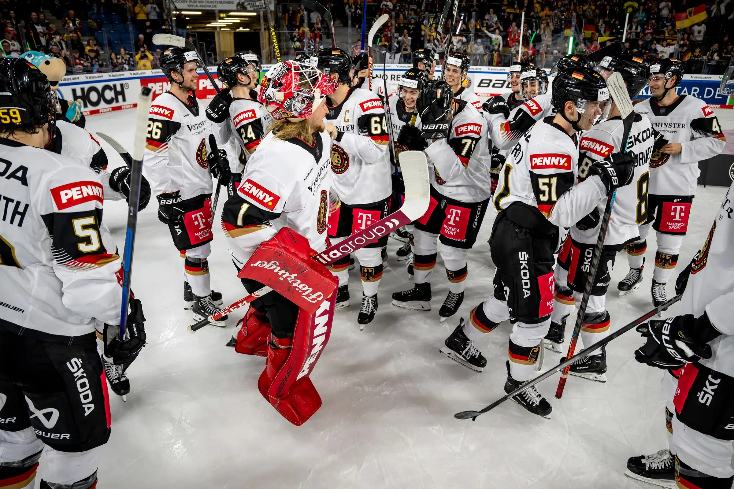 Ice hockey players and coach at the rink side