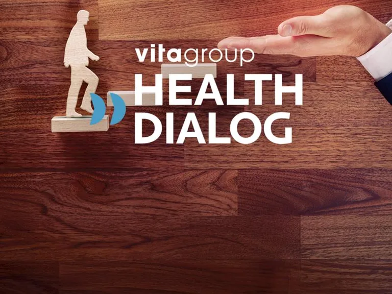 vitagroup Health Dialog – wooden figure climbing a staircase of wooden blocks while a hand places the next block